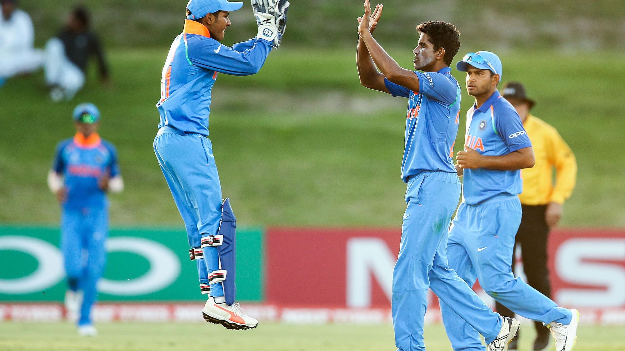 India’s Abhishek Sharma and Aryan Juyal celebrates fall of a wicket.