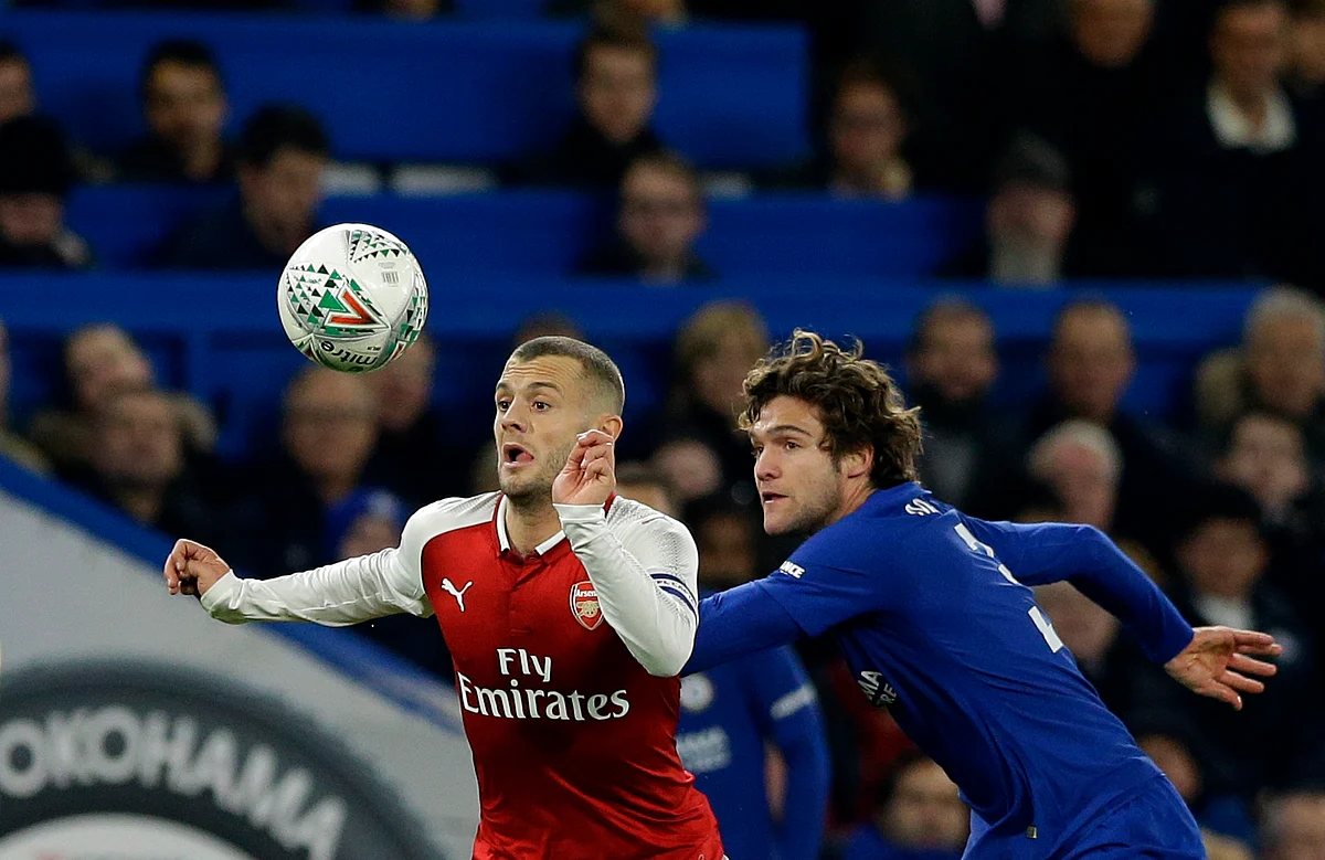 Arsenal’s Jack Wilshere (left) challenges for the ball with Chelsea’s Marcos Alonso.