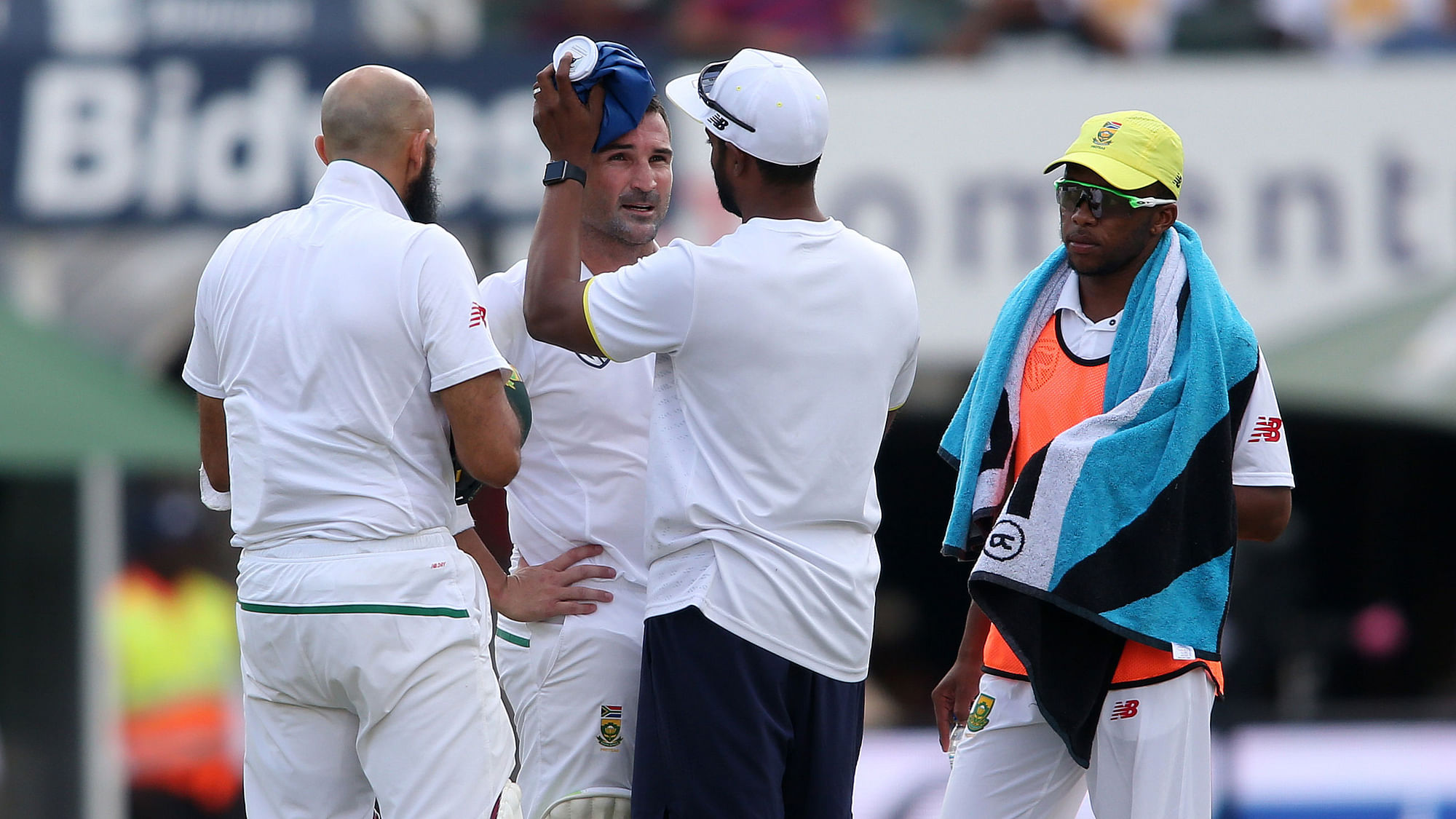 South Africa’s Dean Elgar receives treatment after being hit on the helmet.