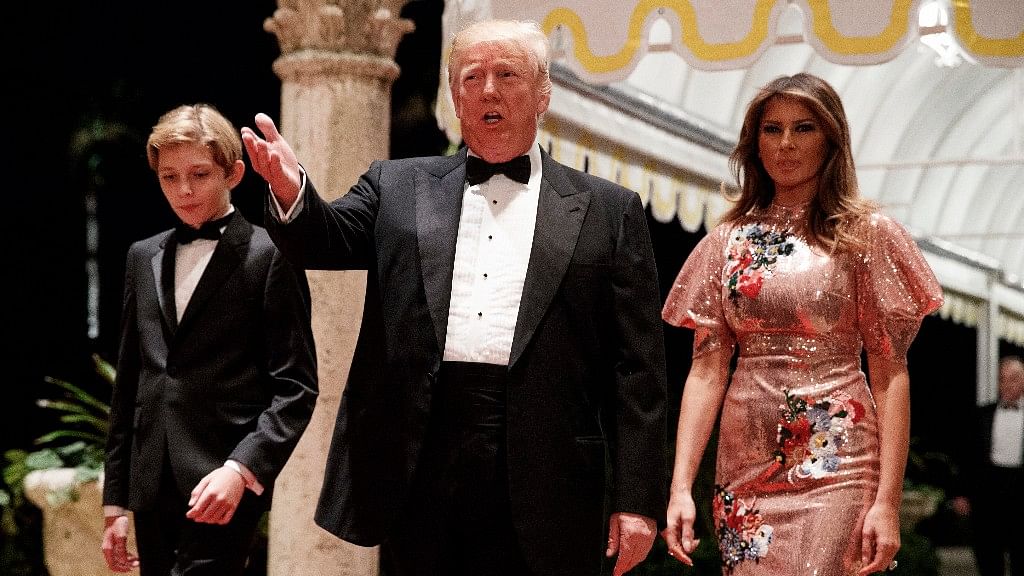 US President Donald Trump (Centre) along with First Lady Melania Trump (Right) and their son Barron.