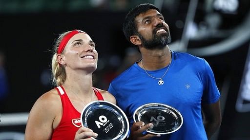 Hungary’s Timea Babos ( left) and partner India’s Rohan Bopanna hold their runner-up trophies at the Australian Open in Melbourne.