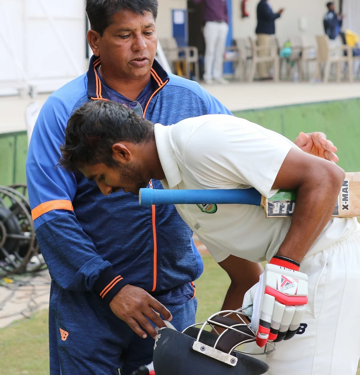 Akshay Wadkar of Vidarbha celebrates his century with coach Pandit on the third day of Ranji Trophy Final between Vidarbha and Delhi in Indore on Dec 31, 2017. 