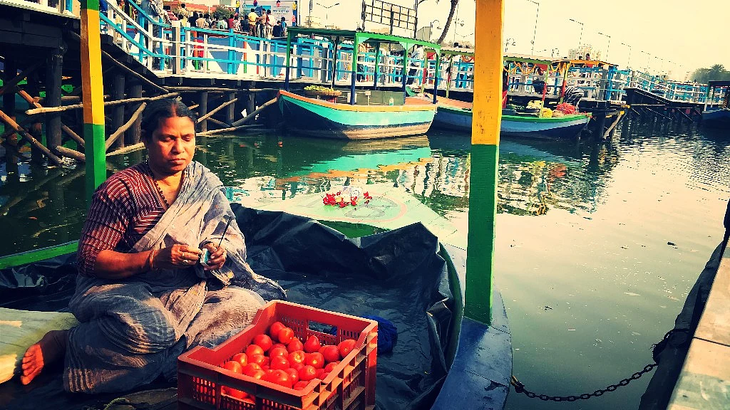 Sabita Halder prays on her boat.
