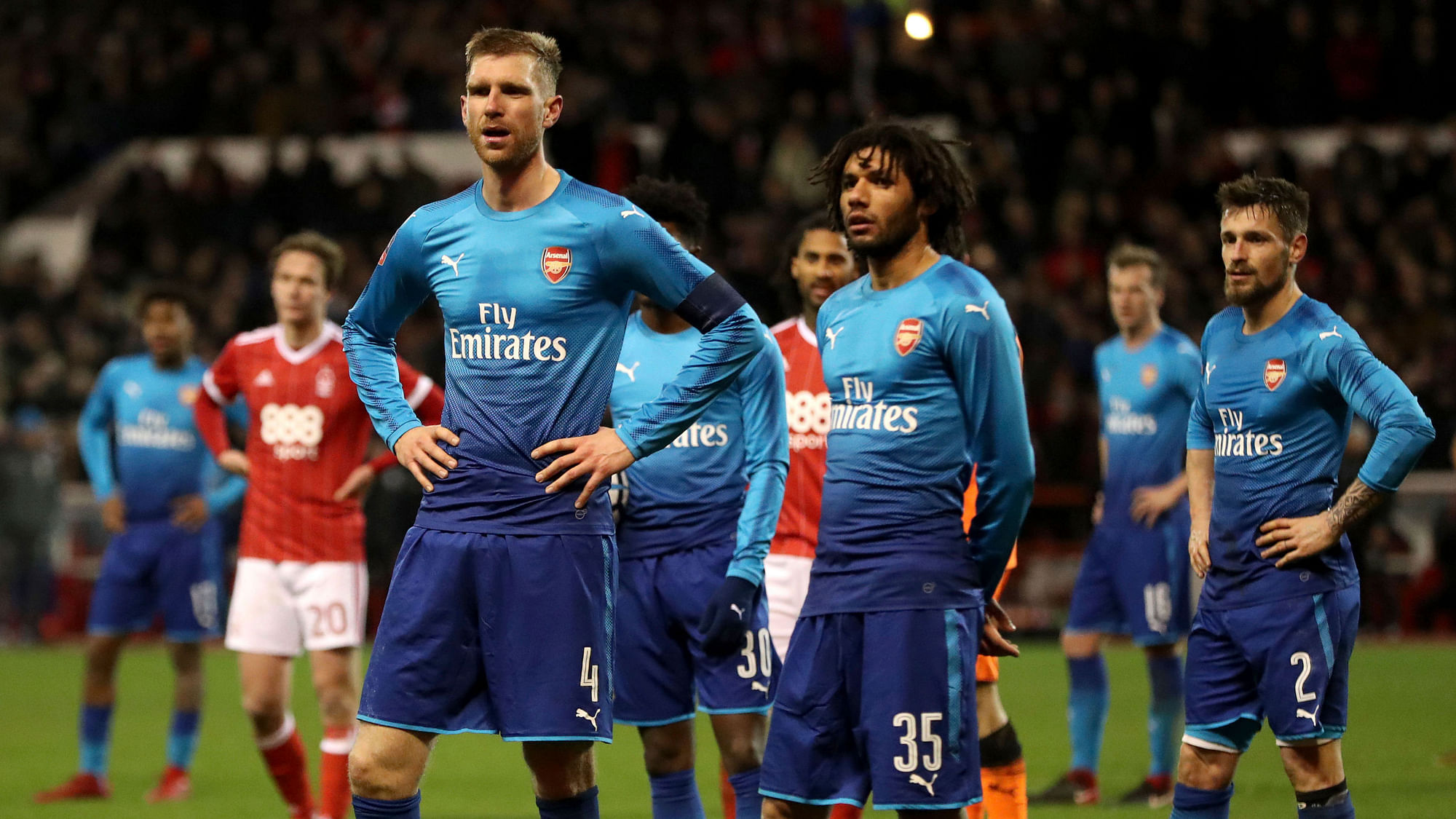 Arsenal’s Per Mertesacker and Mohamed Elneny are dejected during the FA Cup match against Nottingham Forest.