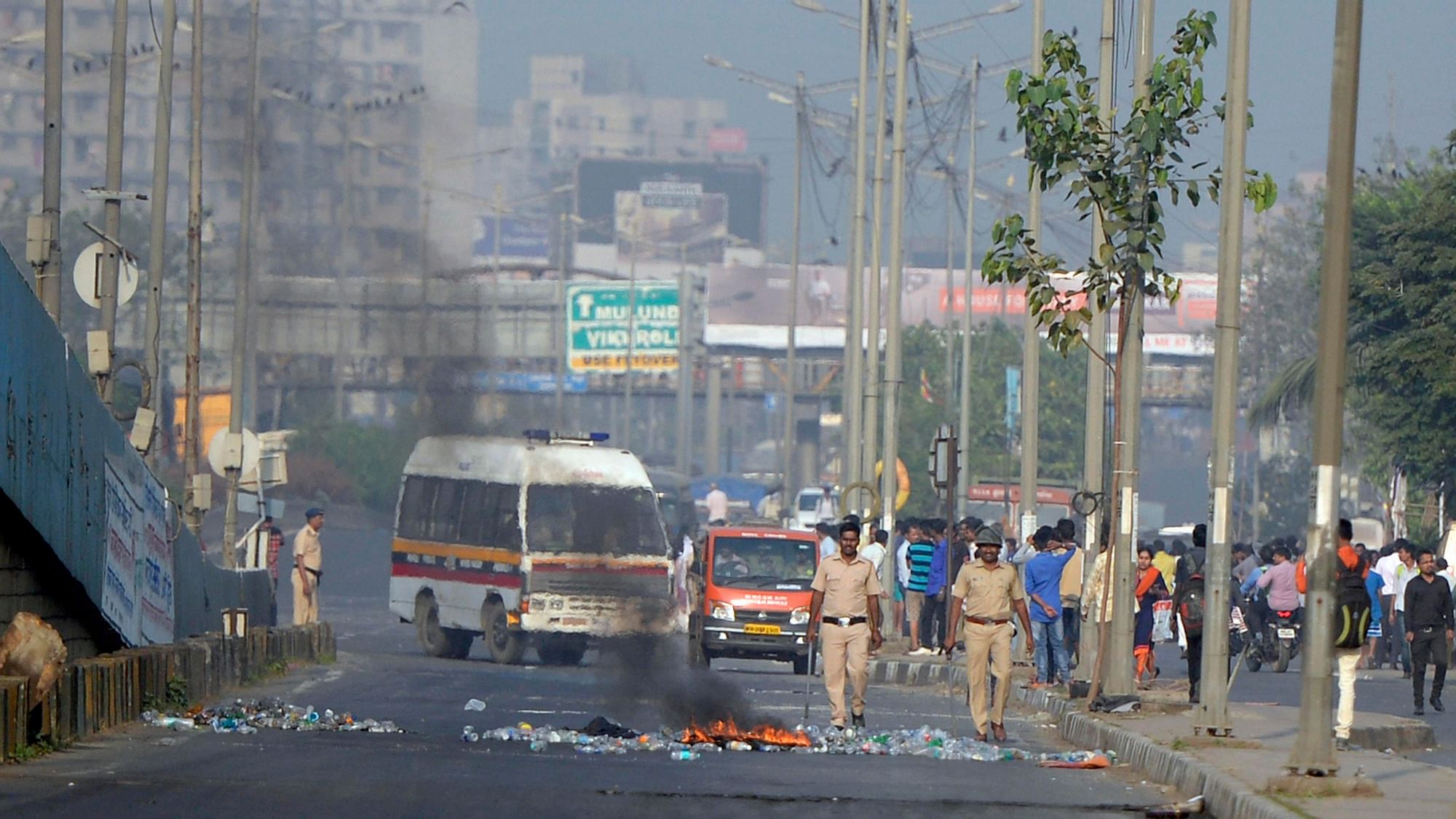 Policemen in Mumbai  try to control the situation after a violent protest by Dalits over the Bhima Koregaon unrest.