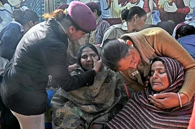 New Delhi: Policewoman console the grief struck relatives of those killed in Bawana factory fire in New Delhi, on Jan 21, 2018. As many as 17 people, including 10 women, were burnt to death or asphyxiated and 30 others injured in a fire in a plastic warehouse which was also used as a godown to store firecrackers in west Delhi