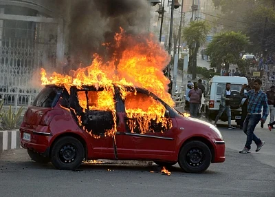 Bhopal: A car torched by people protesting against upcoming film "Padmaavat" in Bhopal on Jan 24, 2018. (Photo: IANS)