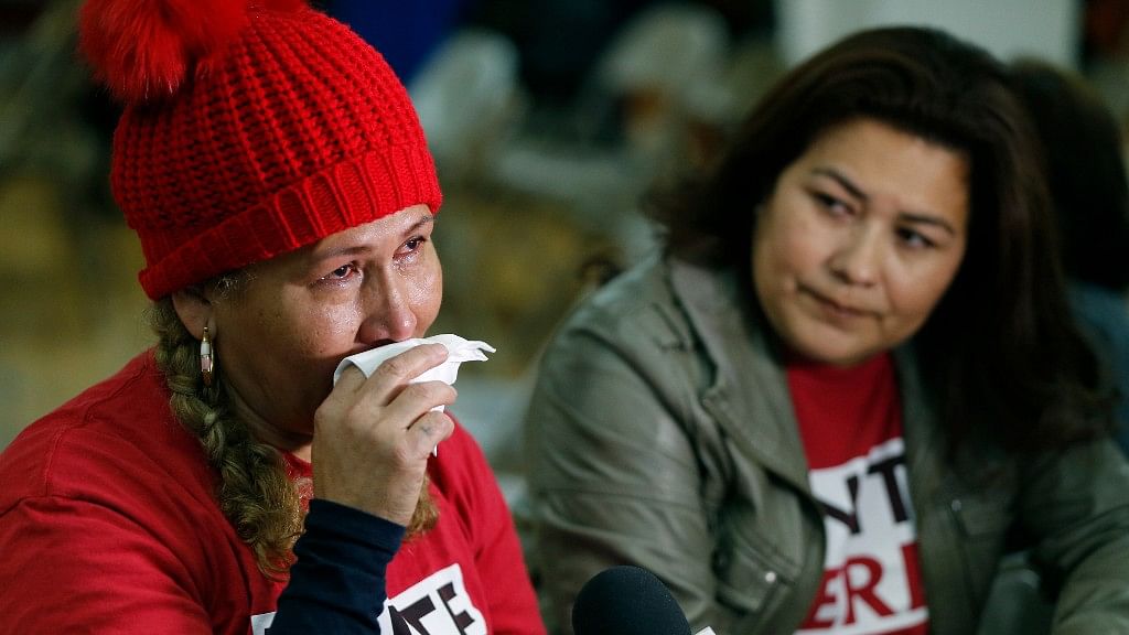 El Salvador immigrants Diana Paredes, left, and Isabel Barrera, react at a news conference following an announcement on Temporary Protected Status for nationals of El Salvador, in Los Angeles, on Monday January 8, 2018.