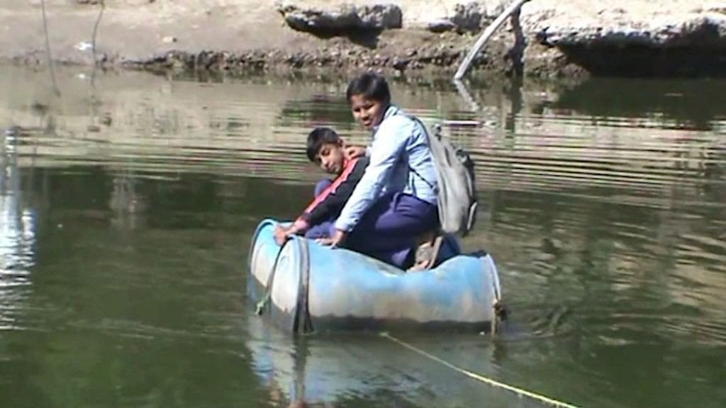 Students at Tungni village in Madhya Pradesh use ‘boats’ made of drums to cross the river and go to school.