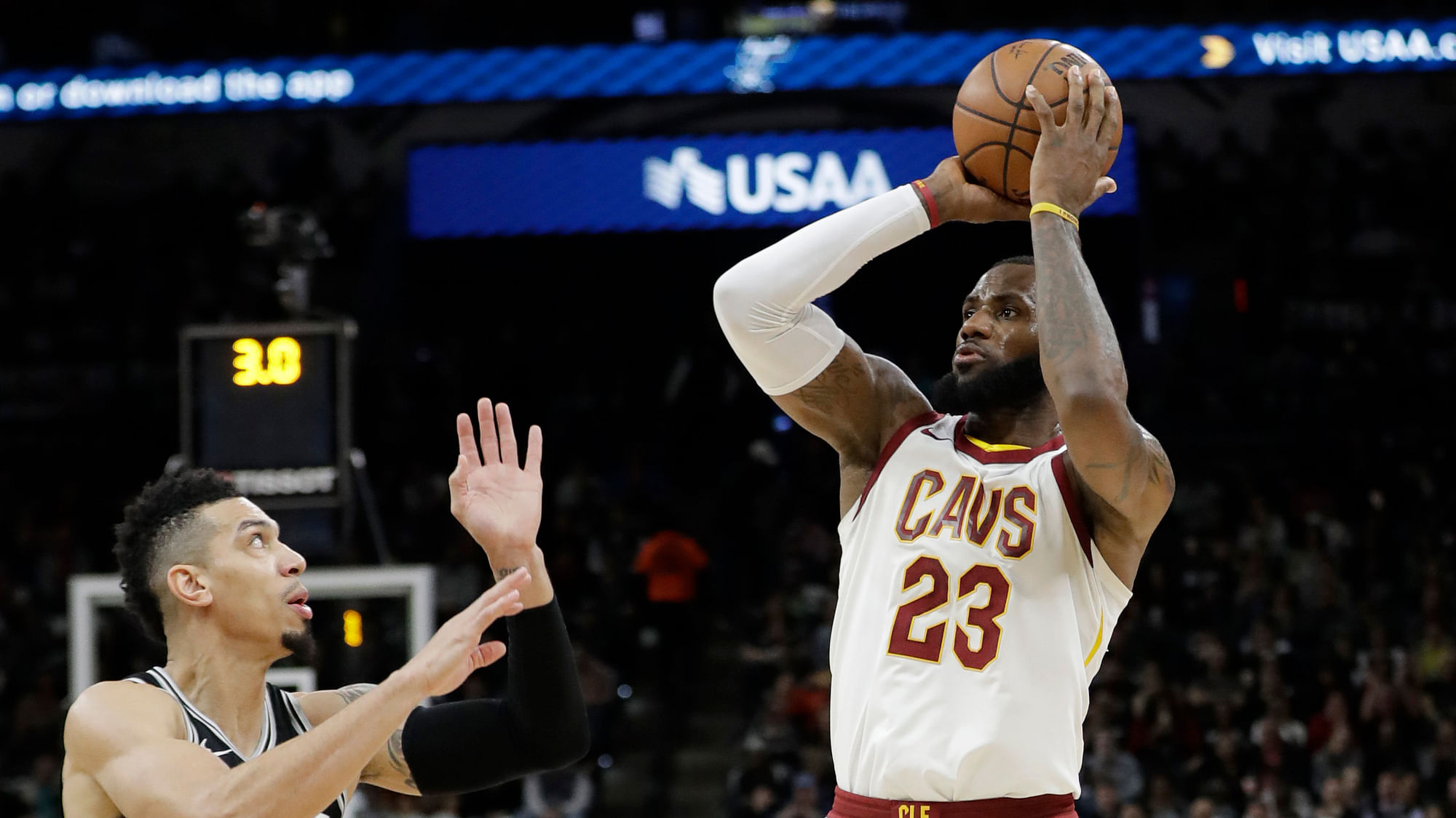 Cleveland Cavaliers forward LeBron James shoots and scores over San Antonio Spurs guard Danny Green.
