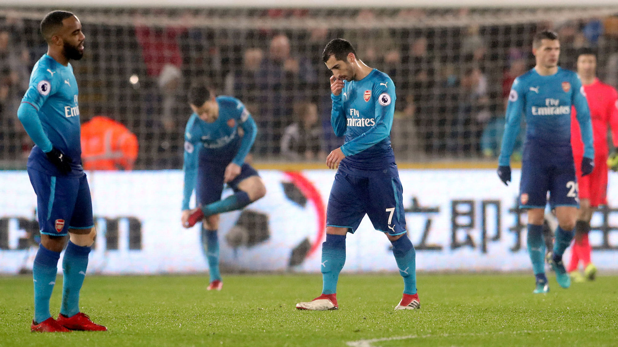 Arsenal’s Henrikh Mkhitaryan, center, looks dejected after Arsenal concede their third goal of the game. <a></a>