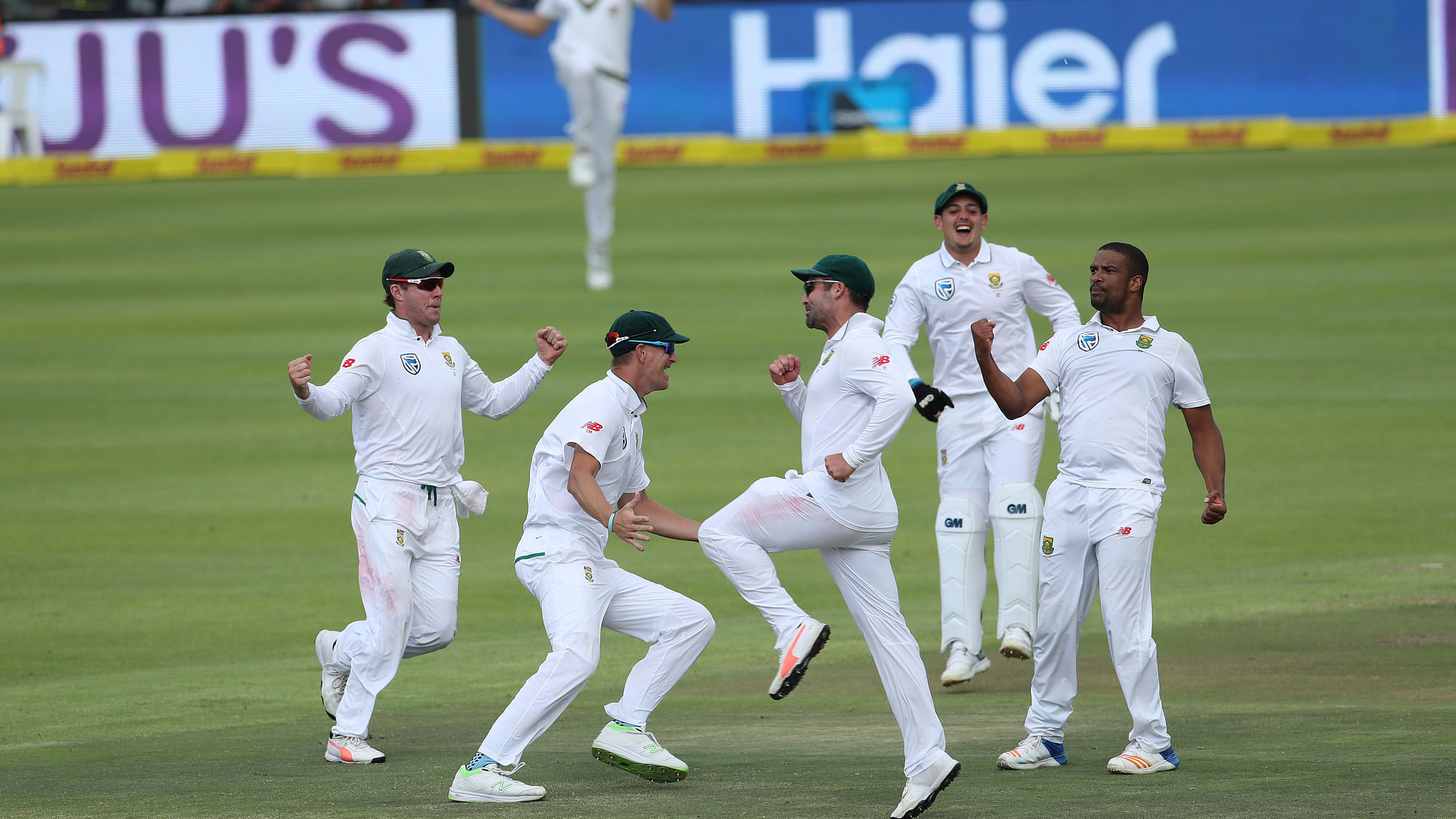 South African players celebrate the fall of an Indian wicket
