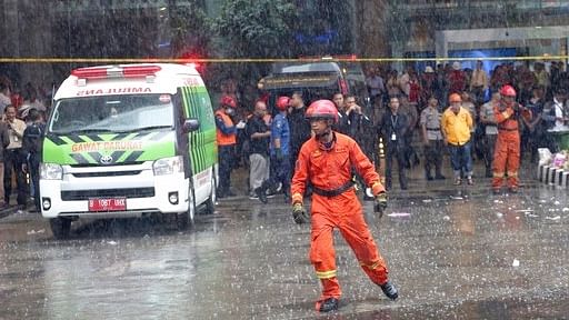 Firefighters work at the site where the Jakarta Stock Exchange tower collapsed in Jakarta.
