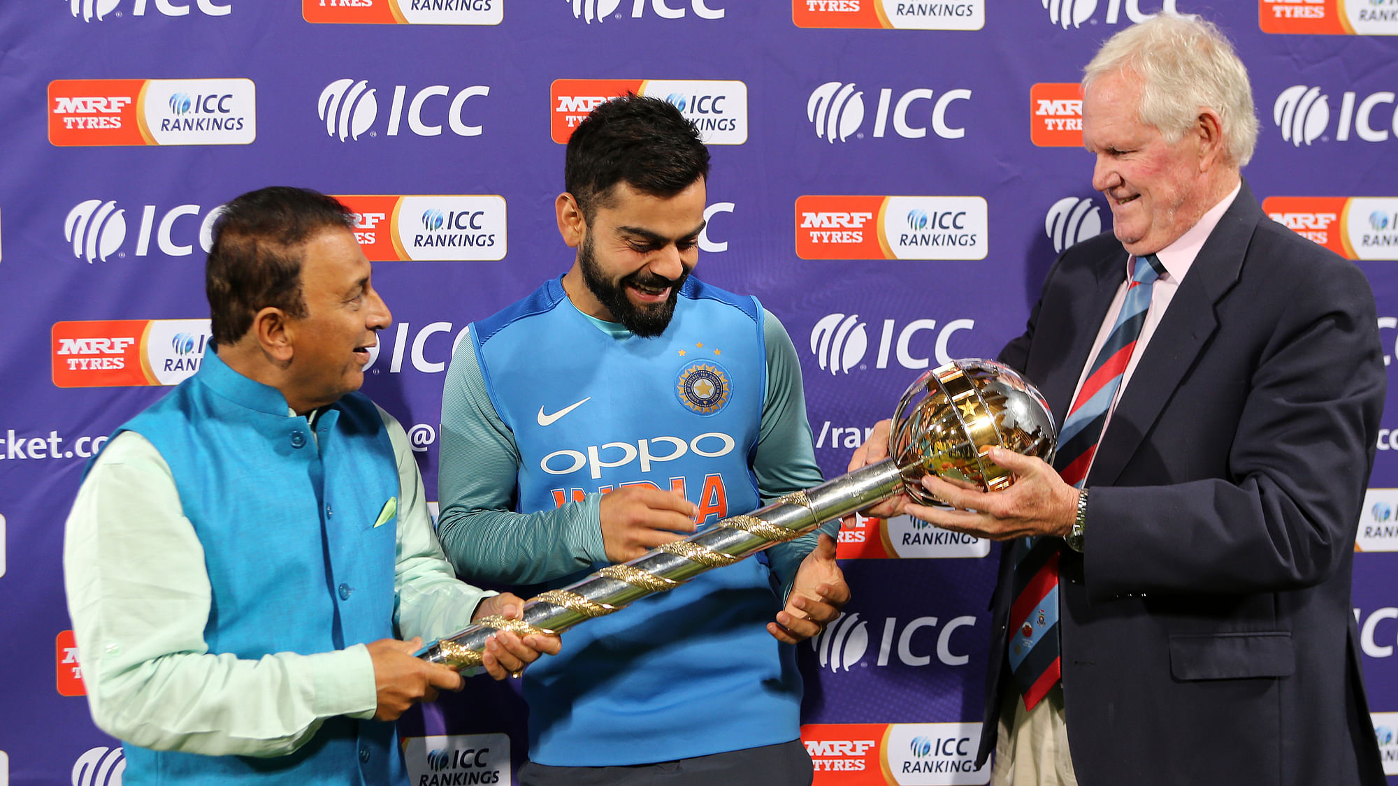Sunil Gavaskar (L) and Graeme Pollock (R) present India captain Virat Kohli with the ICC Test Championship Mace.