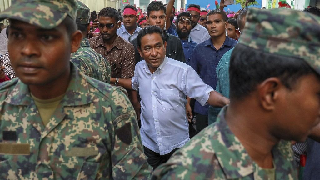 Maldivian President Yameen Abdul Gayoom, centre, surrounded by his bodyguards arrives to address his supporters in Male, Maldives, on 3 February.