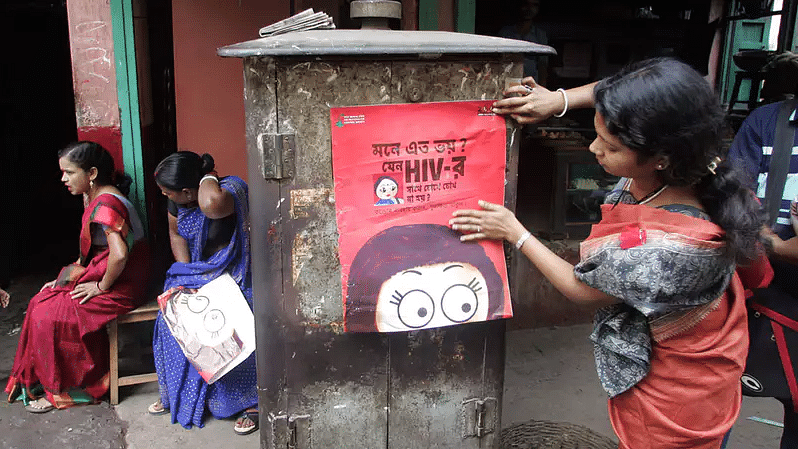 An activist puts up a poster on HIV awareness. Image used for representational purpose.