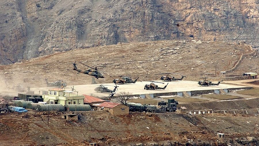Two Turkish military personnel were killed when a helicopter was shot down while carrying out a military operation in Syria.