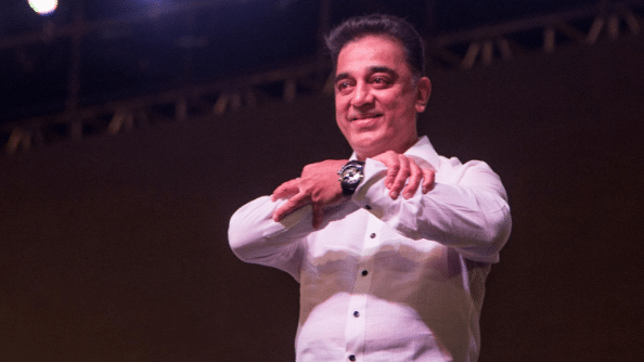 Kamal Haasan forming the symbol of his new party with his hands.