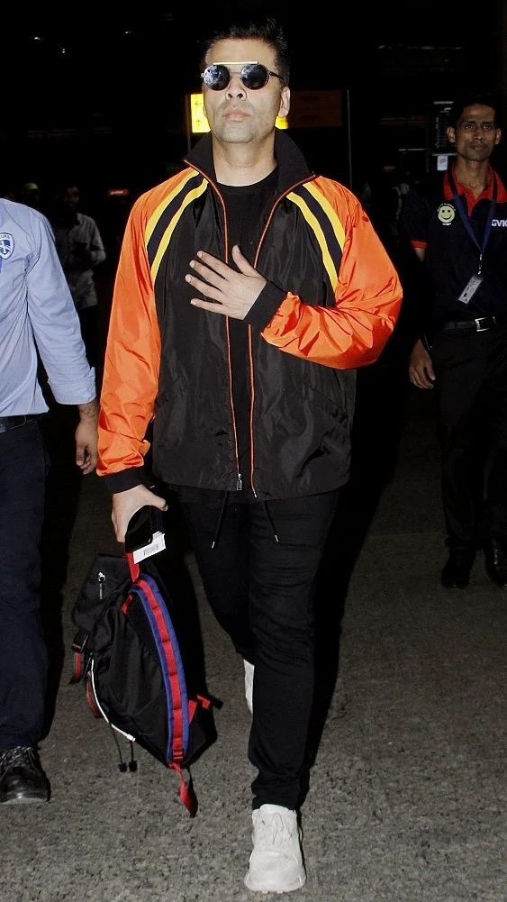 Karan Johar all black with a pinch of orange and yellow is the way to go.