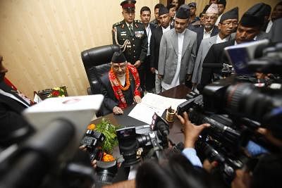 KATHMANDU, Oct. 13, 2015 (Xinhua) -- Newly appointed Prime Minister Khadga Prashad Oli (1st L) talks with the media when he assumes his post at his office at Singha Durbar, Kathmandu, Nepal, Oct. 12, 2015. Chairman of the Communist Party of Nepal (Unified Marxist-Leninist) (CPN-UML) Khadga Prashad Oli, also known as KP Oli was elected as the 38th Prime Minister of Nepal on Oct. 11. (Xinhua/Pratap Thapa)