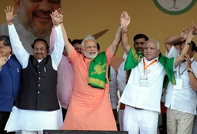Davanagere: Prime Minister Narendra Modi and BJP Karnataka chief BS Yediyurappa during a BJP rally ahead of Karnataka Assembly Polls at Davanagere, Karnataka on 27 Feb 2018. (Photo: IANS)