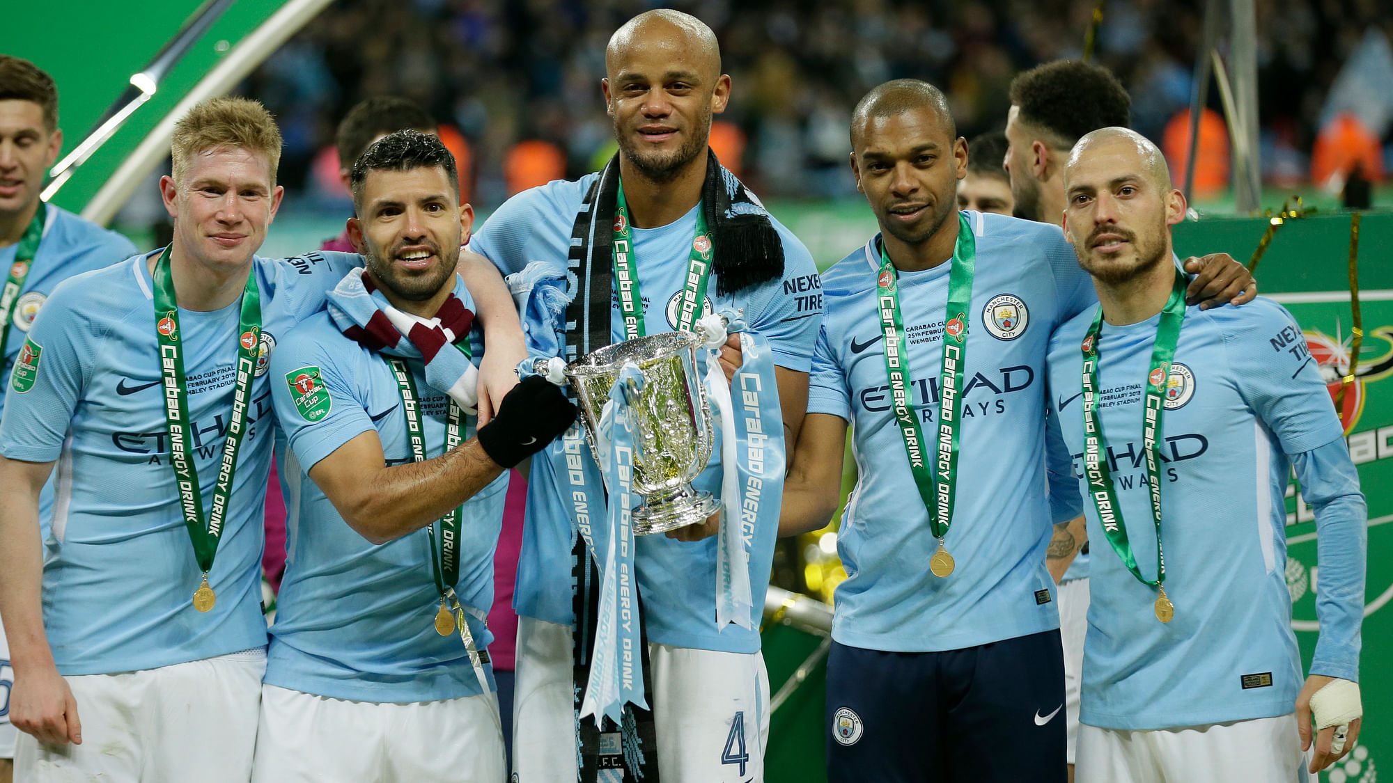 Manchester City players celebrate after winning the English League Cup Final against Arsenal 3-0 at Wembley stadium in London on Sunday.