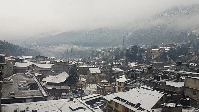 Manali: A view of Manali after fresh snowfall covers roof of houses and the tree-covered mountains on Feb 12, 2018. (Photo: IANS)