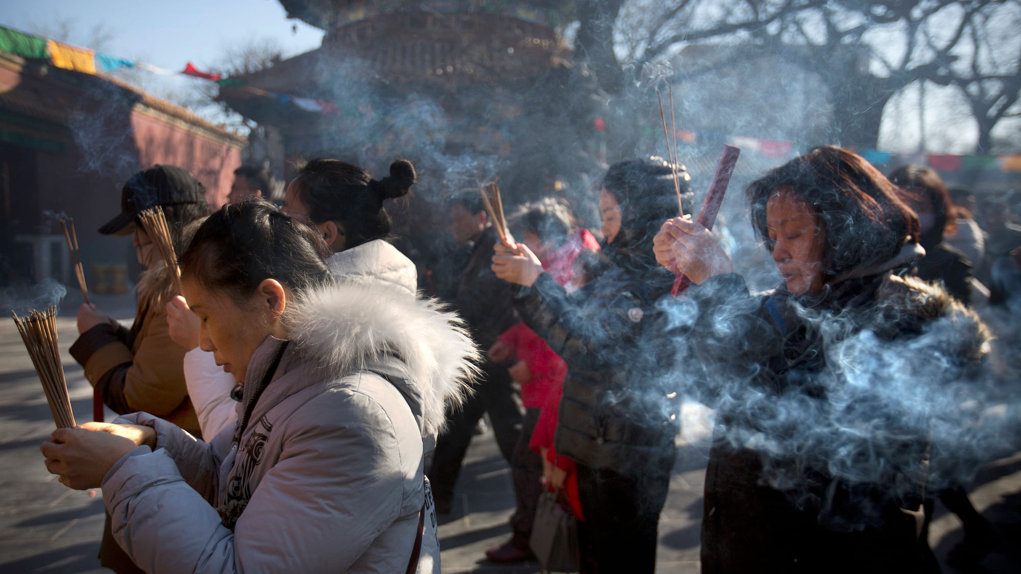 People burn incense sticks to celebrate Chinese New Year.