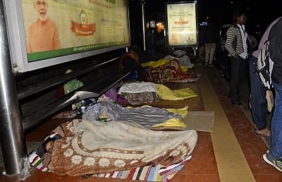 New Delhi: People sleep on a Delhi bus stop on a cold night on Jan 5, 2018. (Photo: Bidesh Manna/IANS)