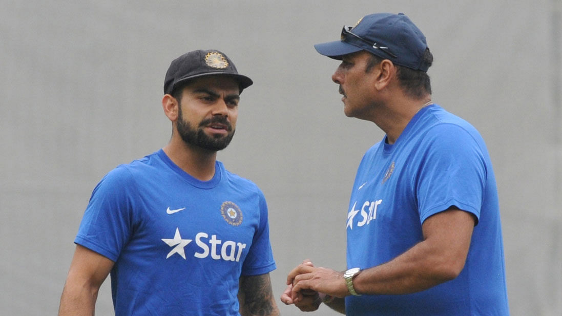 Virat Kohli and Ravi Shastri attend a practice session.
