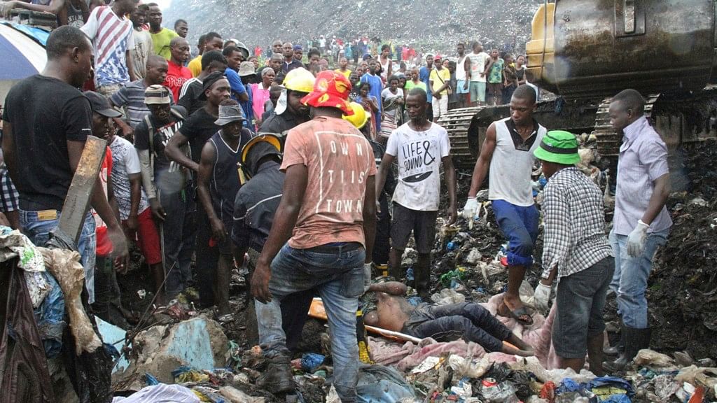 Rescuers search for survivors at the collapse of a garbage mound in Maputo, Mozambique.