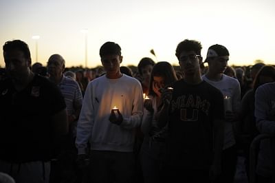 PARKLAND, Feb. 16, 2018 (Xinhua) -- People hold candles during a vigil for the victims of the shooting at Marjory Stoneman Douglas High School, in Parkland, Florida, the United States, Feb. 15, 2018. Seventeen people were killed in a mass shooting in a high school in Florida in the United States Wednesday, local police said. (Xinhua/Liu Yang/IANS)