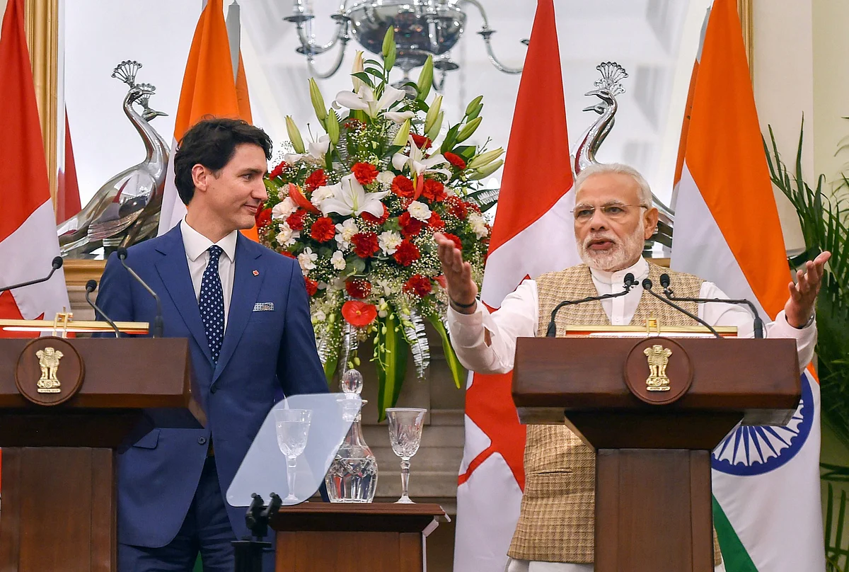 PM Modi speaks as his Canadian counterpart Justin Trudeau looks on, during their joint press conference