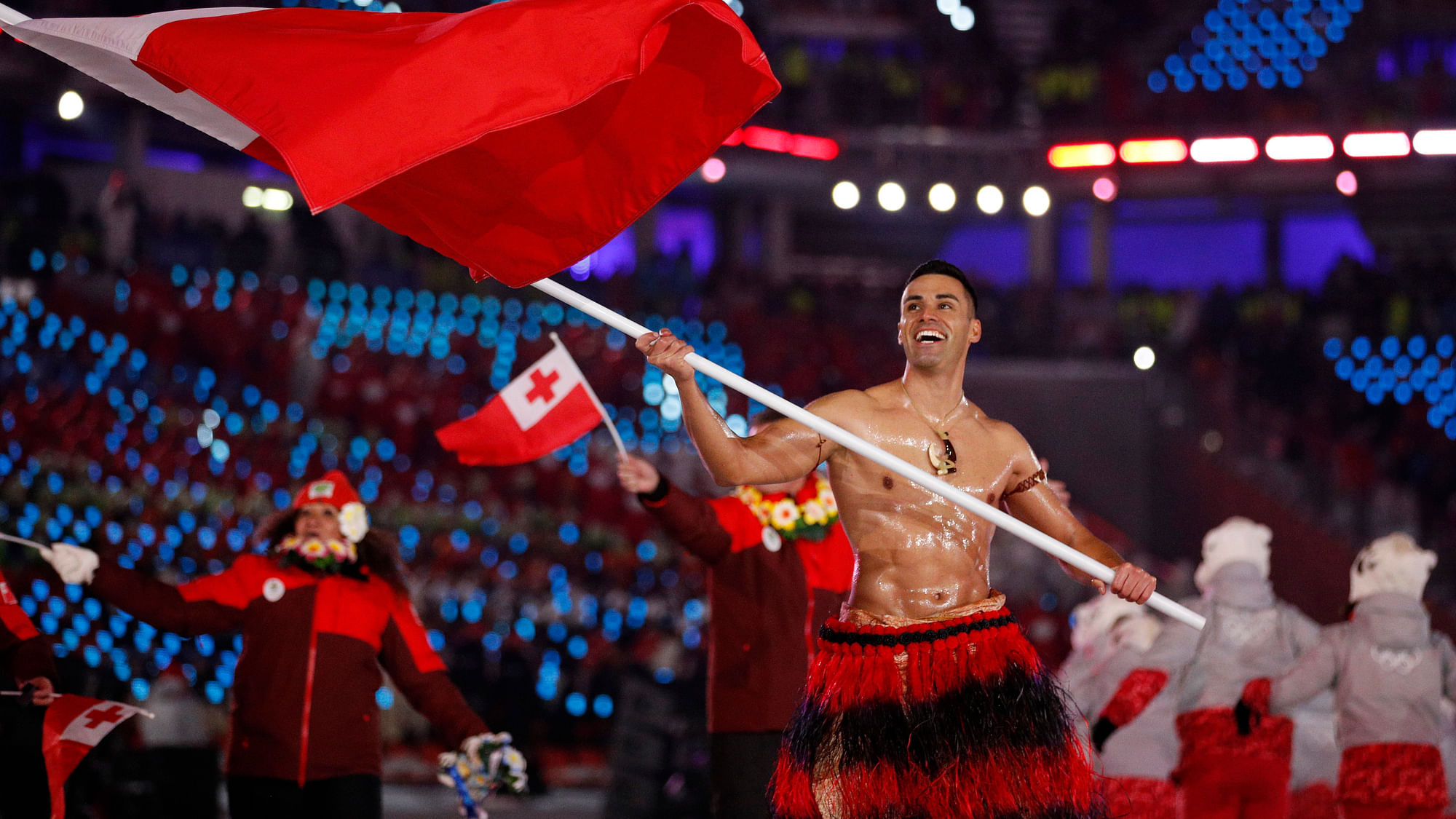 Pita Taufatofua carries the flag of Tonga during the opening ceremony of the 2018 Winter Olympics in Pyeongchang, South Korea, Friday, Feb. 9, 2018.&nbsp;
