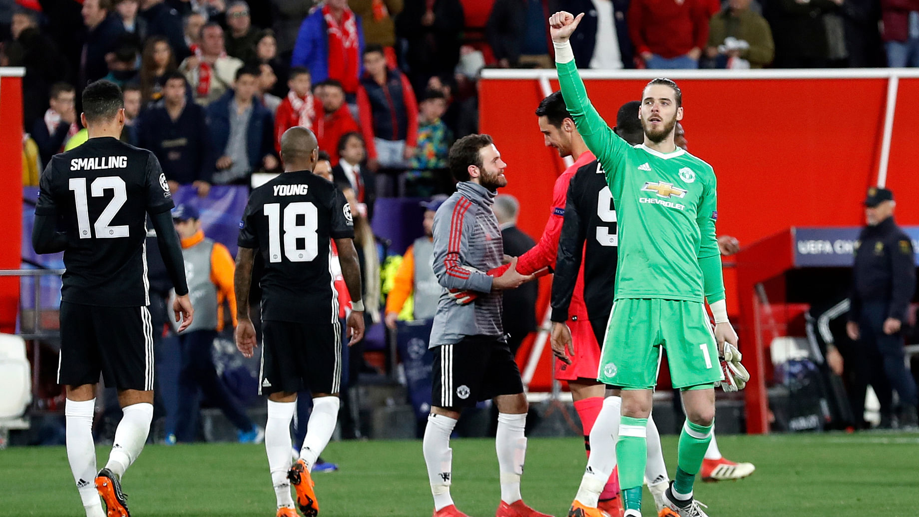 Manchester United goalkeeper David de Gea (right) gestures to the supporters at the end of the Champions League round of sixteen  match against Sevilla FC.