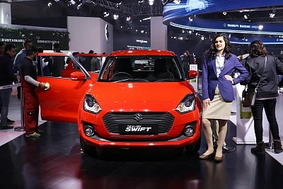 Greater Noida: A model showcases the all new Swift at the Auto Expo 2018 in Greater Noida on Feb 11, 2018. (Photo: IANS)
