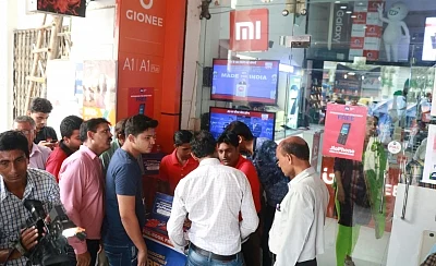 New Delhi: People wait in queues during the first day of JioPhone pre-booking in New Delhi on Aug 24, 2017. (Photo: IANS)