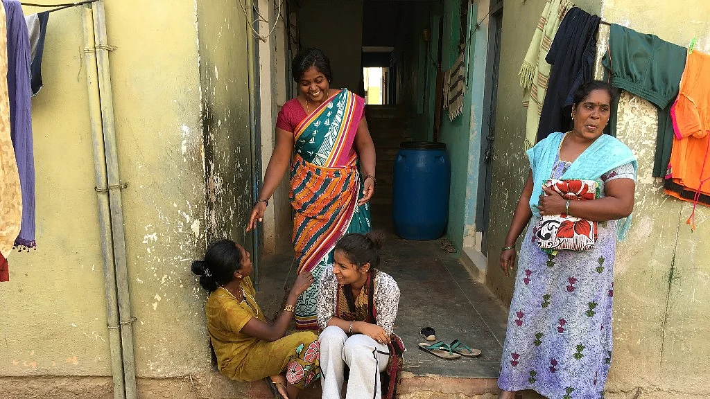 Vasugi Vasu (sitting in the centre) has to walk two kilometres a day to buy basic provisions.