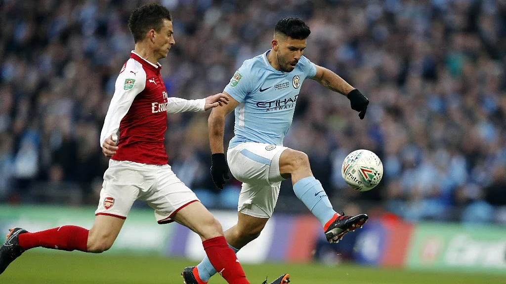 Manchester City’s Sergio Aguero (right) scores the opening goal during the English League Cup final soccer match against Arsenal on Sunday.