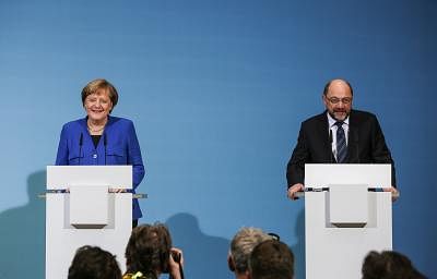 BERLIN, Jan. 12, 2018 (Xinhua) -- German Chancellor and leader of German Christian Democratic Union (CDU) Angela Merkel (L) and leader of German Social Democratic Party (SPD) Martin Schulz attend a joint press conference after coalition talks at the headquarters of SPD, in Berlin, Germany, on Jan. 12, 2018. German Chancellor Angela Merkel