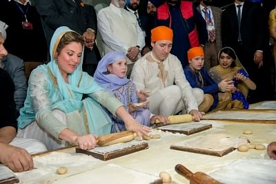 Amritsar: Canadian Prime Minister Justin Trudeau along with his wife Sophie Gregoire Trudeau and children help in preparing Guru Ka Langar during their visit to the Golden Temple in Amritsar on Feb 21, 2018. (Photo: IANS)
