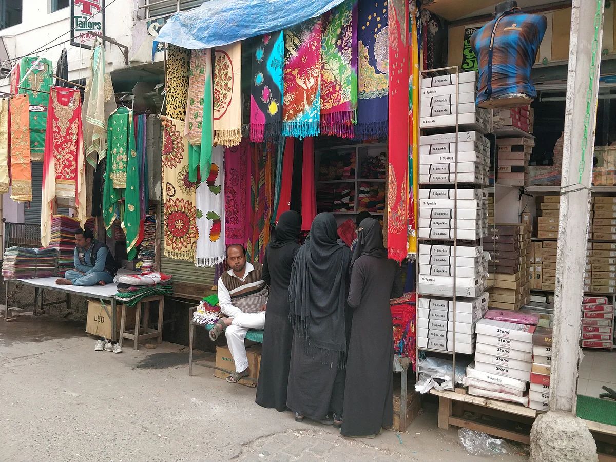 Burqa-clad women at a Muslim-owned shop in a Kasganj market.