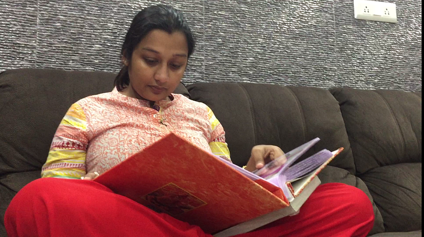 Shampa looks at old photo albums of Oyetri.
