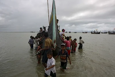 Dakhinpara: Rohingya refugees arrive at Shah Porir Dwip in Dakhinpara ofBangladesh from Rasidong in Myanmar, on Sept 13, 2017. (Photo: bdnews24/IANS)