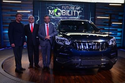 New Delhi: Mahindra Group Executive Chairman Anand Mahindra, Mahindra and Mahindra Ltd Automotive Sector president Rajan Wadhera and MD Pawan Goenka unveil the Mahindra XUV500 at the Auto Expo 2018 in New Delhi on Feb 7, 2018. (Photo: IANS)