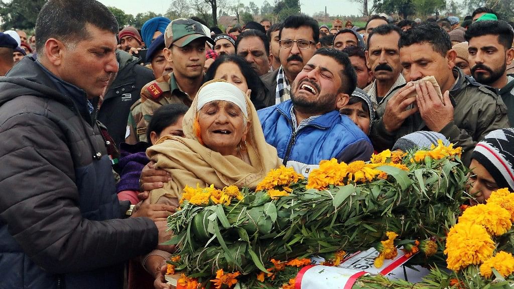 The family of JCO Madan Lal Choudhary, who was martyred in the Sunjwan terror attack, mourn next to his mortal remains.&nbsp;