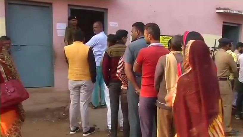 Chanderi: People wait to cast their votes during bypolls to Kolaras and Mungaoli assembly seats in Chanderi of Madhya Pradesh