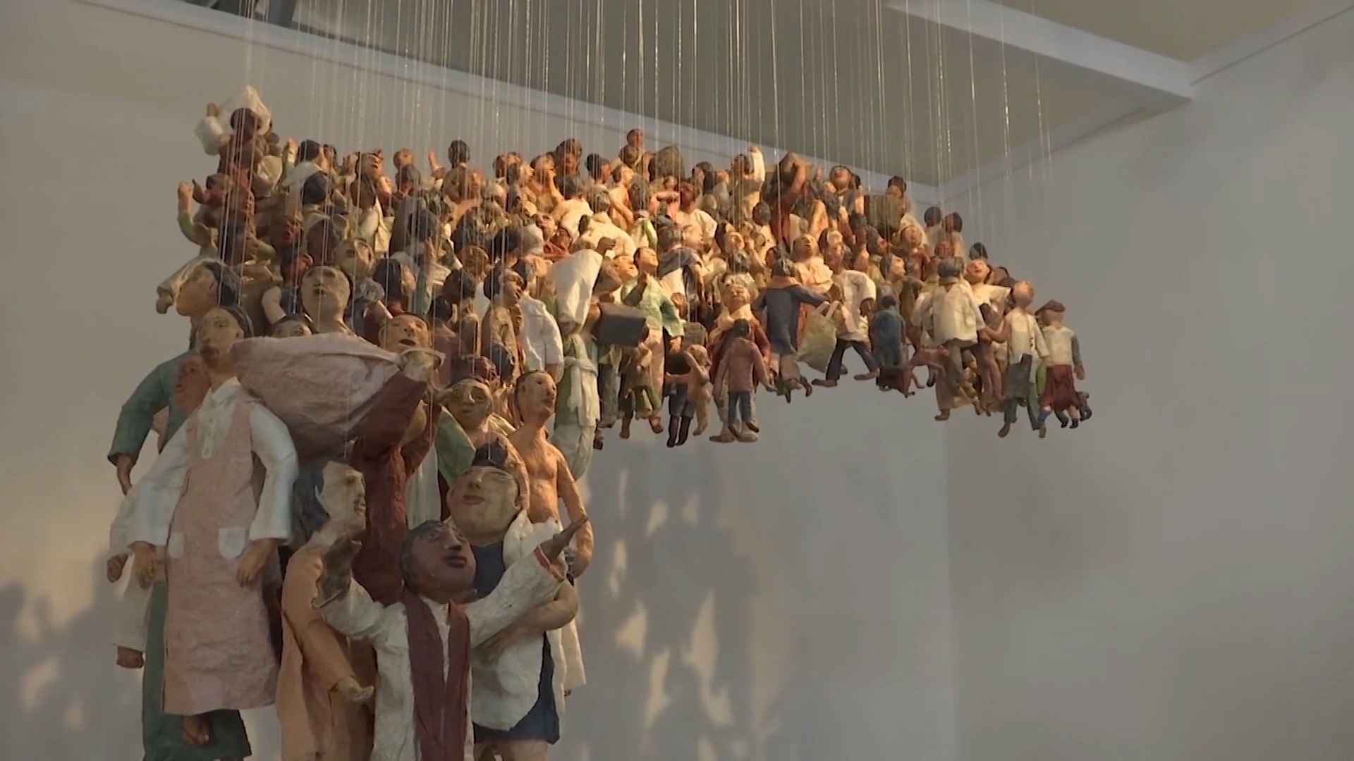 Sculptures hanging by a thread depict the plight of displaced people