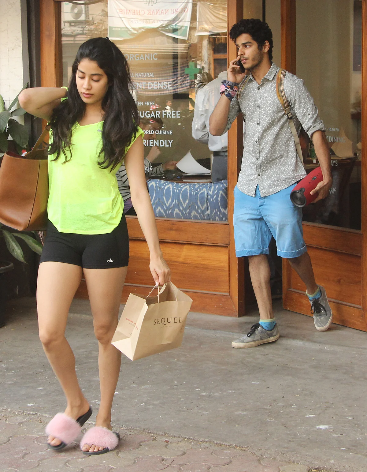 Janhvi Kapoor and Ishaan walk out of a health cafe.