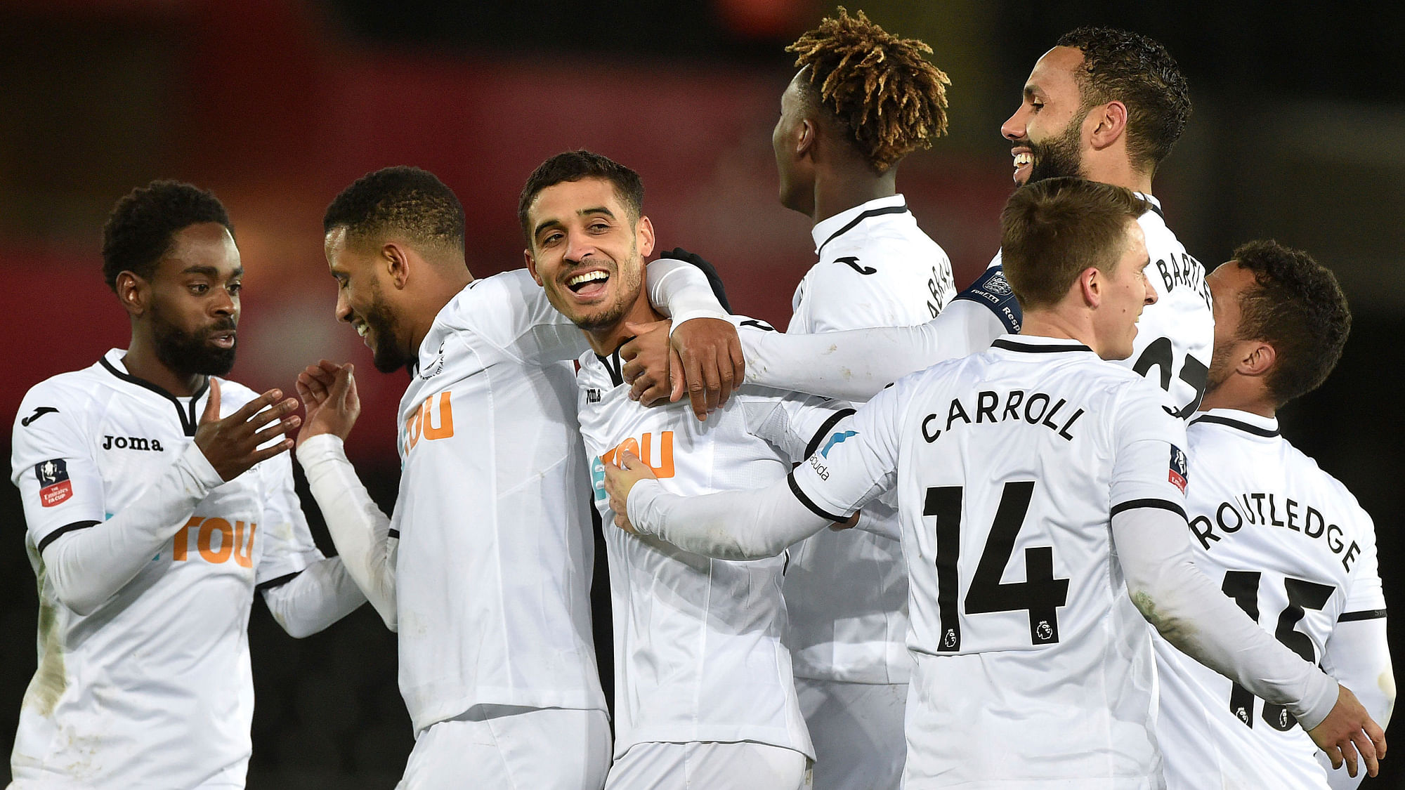 Swansea City’s Kyle Naughton celebrates with his team-mates after scoring his side’s fifth goal.<a></a>